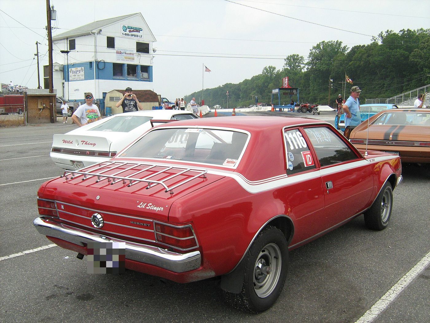 Rear three-quarter of a red 1971 Hornet SC/360 with white stripe, deck-lid rack and HORNET lettering on the tail panel
