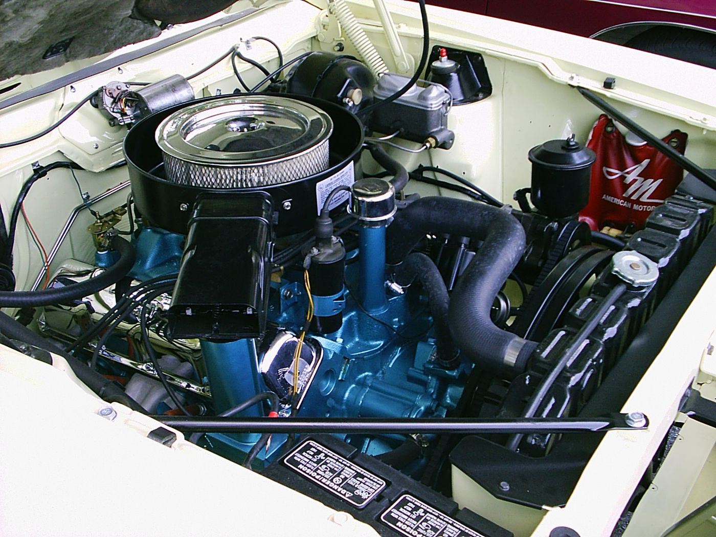 The 390 V8 in a white 1970 Javelin SST, with the ram-air ducting and blue engine paint