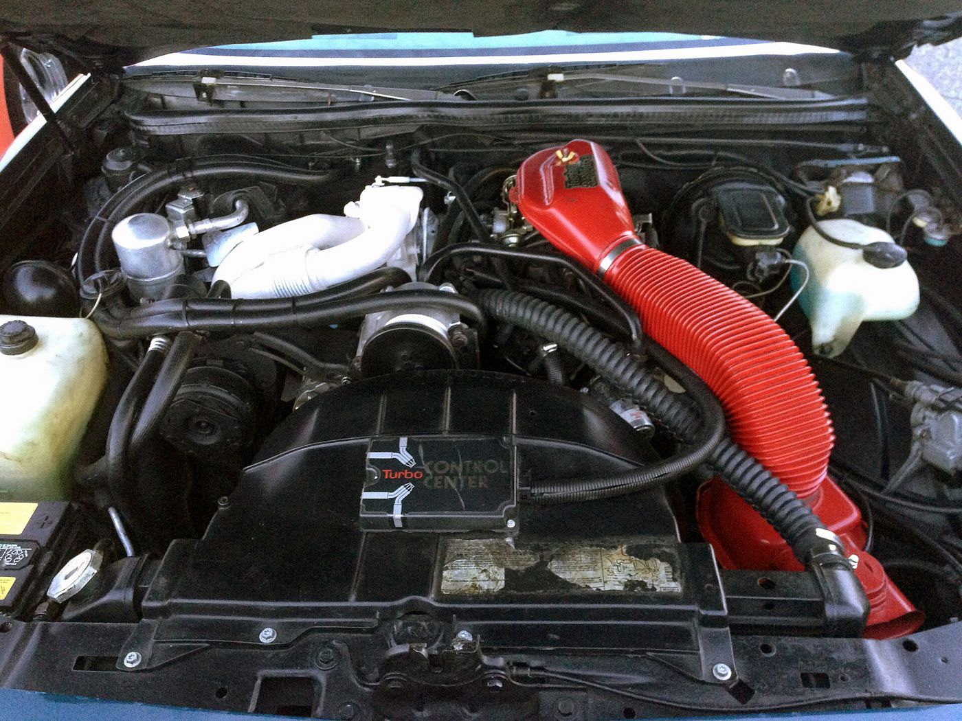 Engine bay of a 1978 Buick Regal with the turbocharged 3.8-litre V-6 and red air intake duct