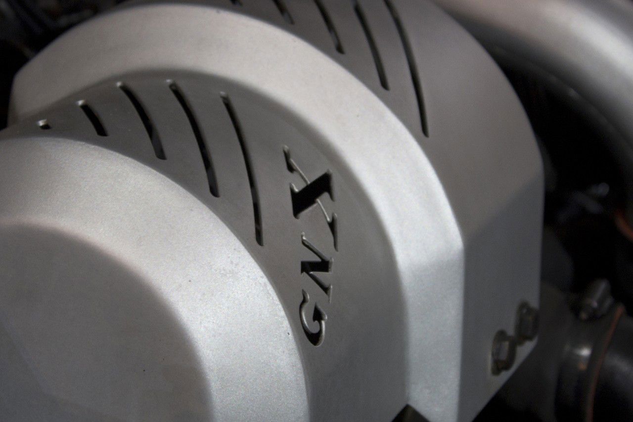 Close-up of the silver-painted intercooler cover of a 1987 Buick GNX, cast with GNX lettering