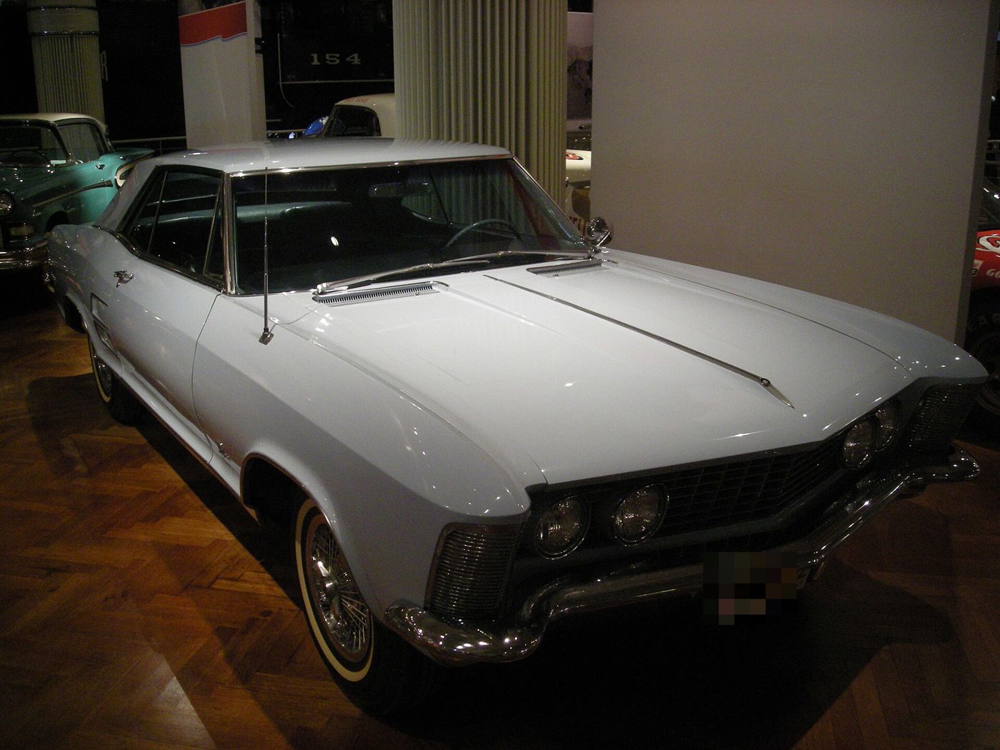 Silver-white 1963 Buick Riviera, front three-quarter, on display in a museum