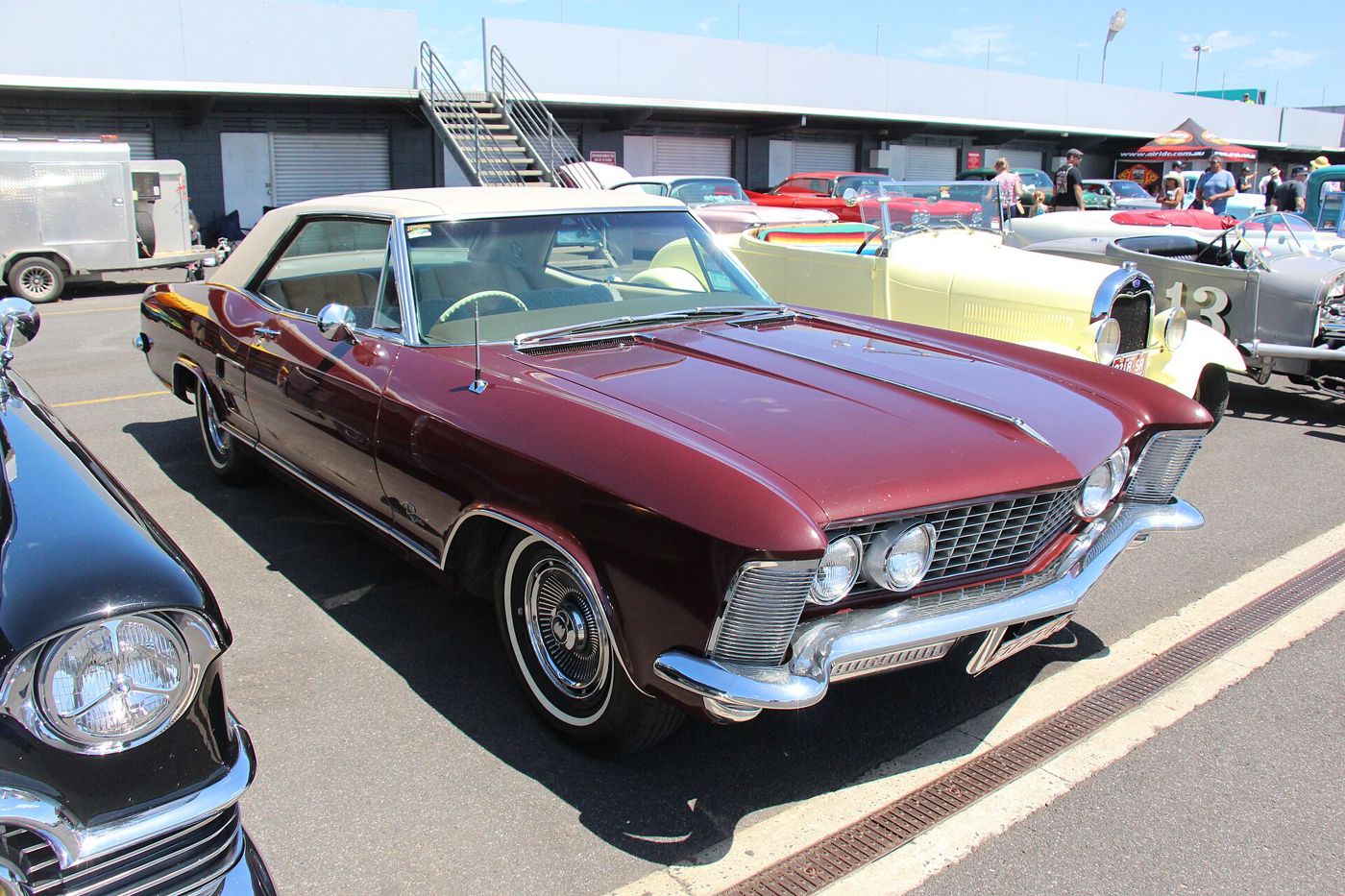 Burgundy 1963 Buick Riviera two-door hardtop, front three-quarter, at a car show
