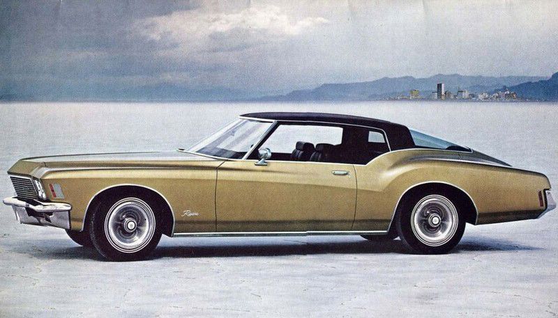 Brochure photo: gold 1971 Buick Riviera with black vinyl top in full side view on a salt flat
