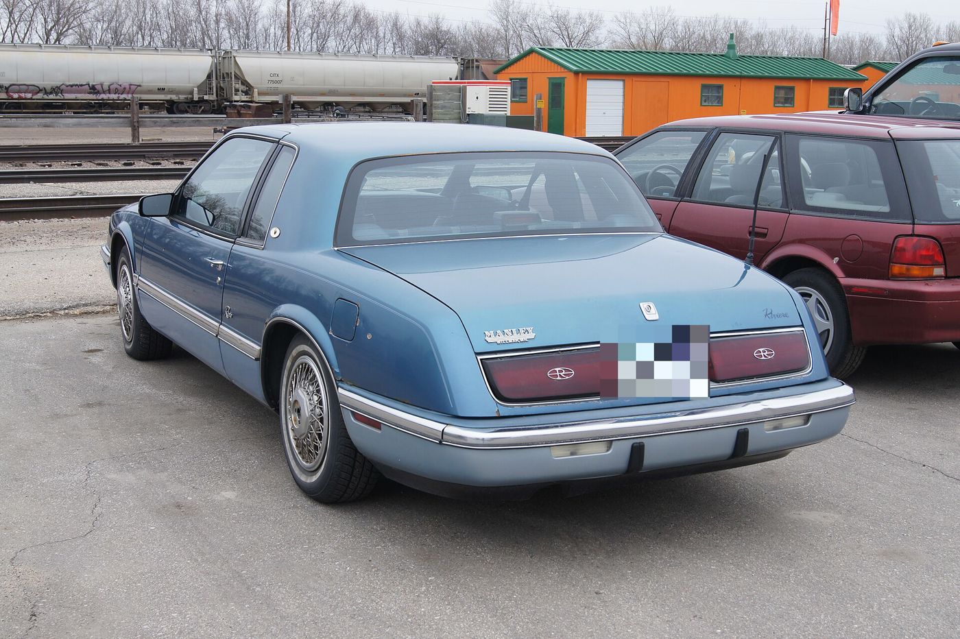 Blue 1989 Buick Riviera from the rear three-quarter, showing the longer 1989 tail