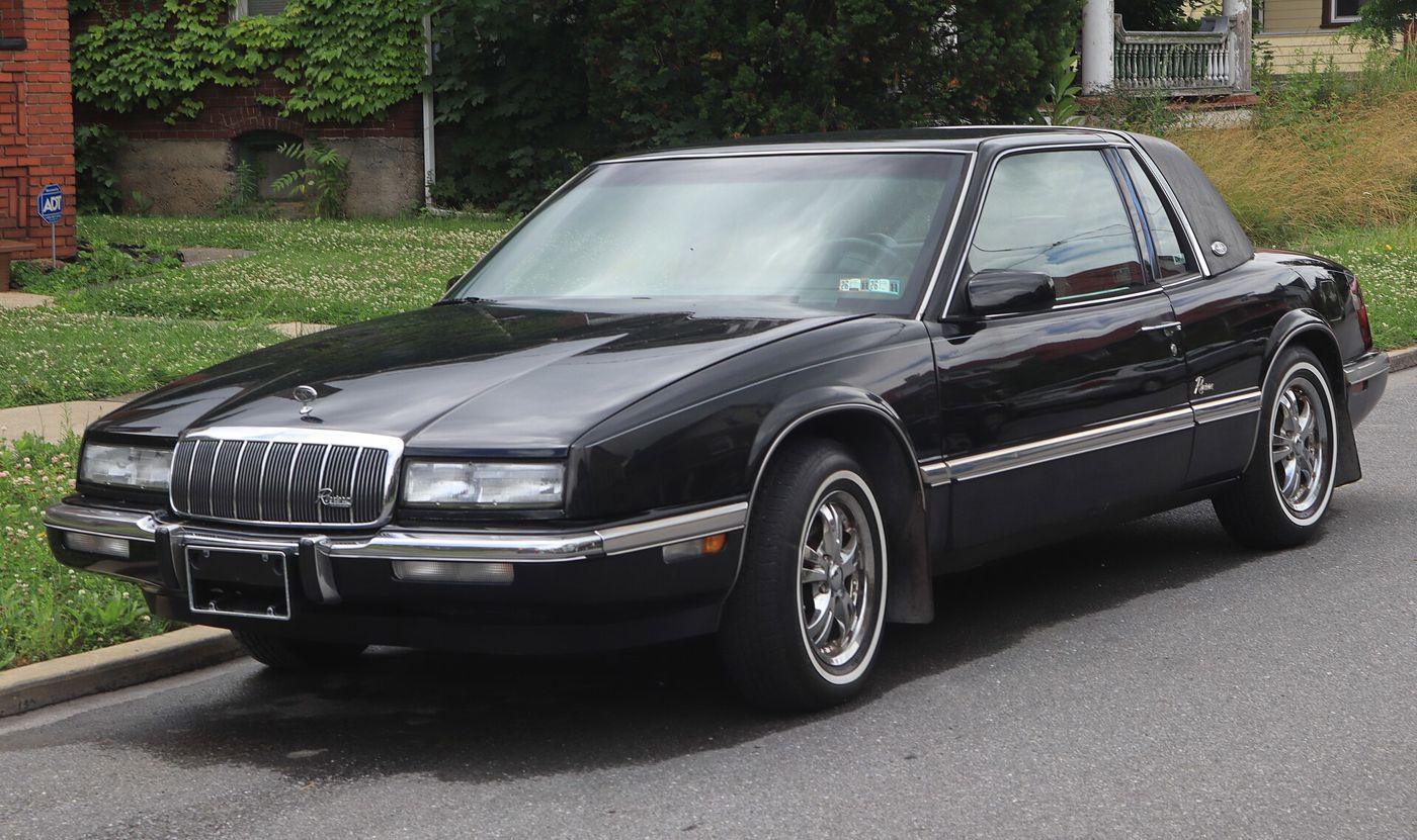 Black 1993 Buick Riviera coupe, front three-quarter, at a curb