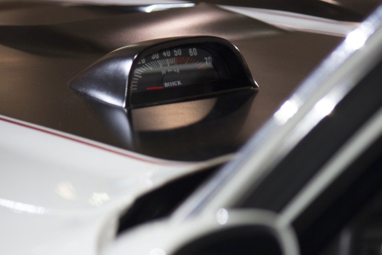Close-up of the hood-mounted tachometer on a white 1970 Buick GSX