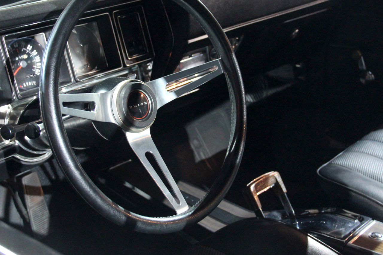 Interior of a 1970 Buick GSX: three-spoke sport steering wheel, dash gauges and console shifter