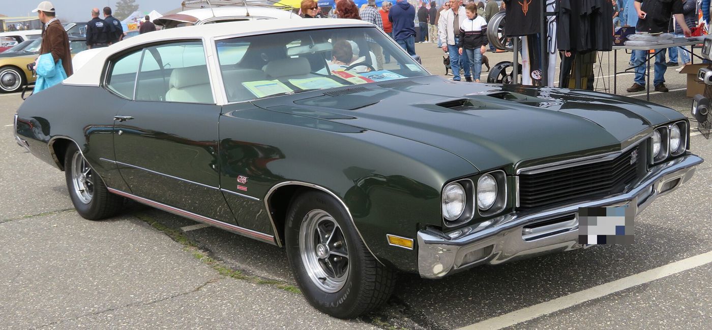 Dark-green 1972 Buick Skylark GS with white vinyl top, front three-quarter, at a car show