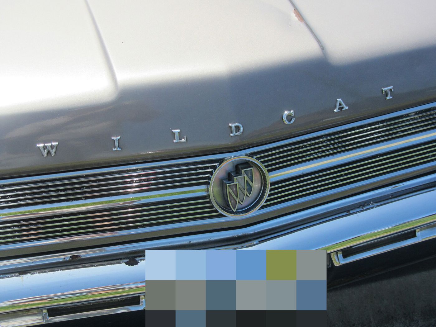 Close-up of the grille and WILDCAT hood lettering on a silver 1964 Buick Wildcat