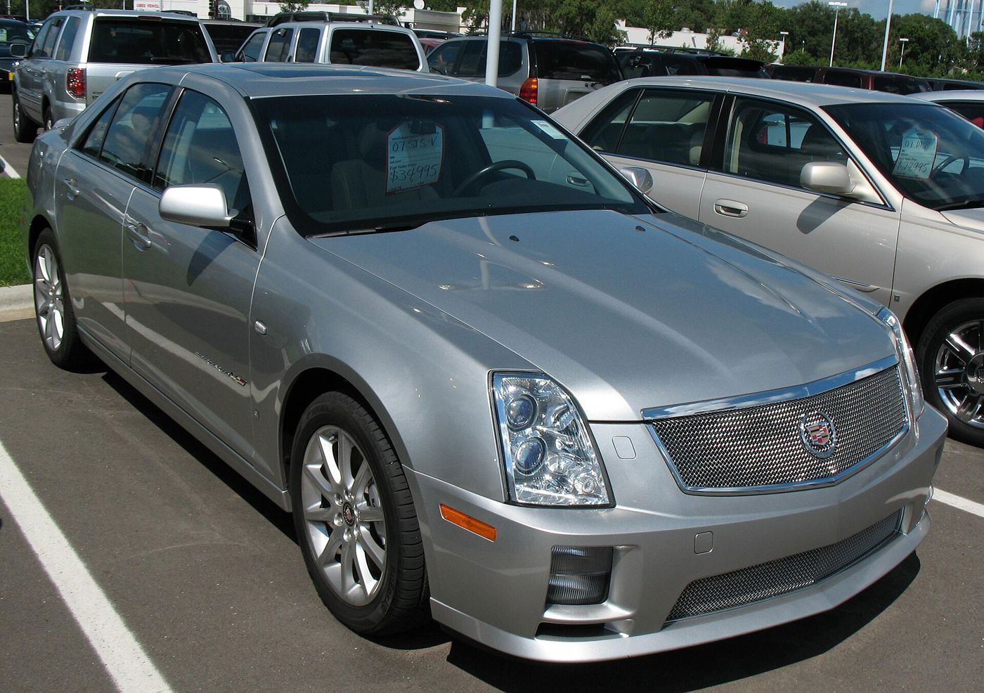 Silver 2007 Cadillac STS-V sedan with mesh grille, front three-quarter, in a parking lot