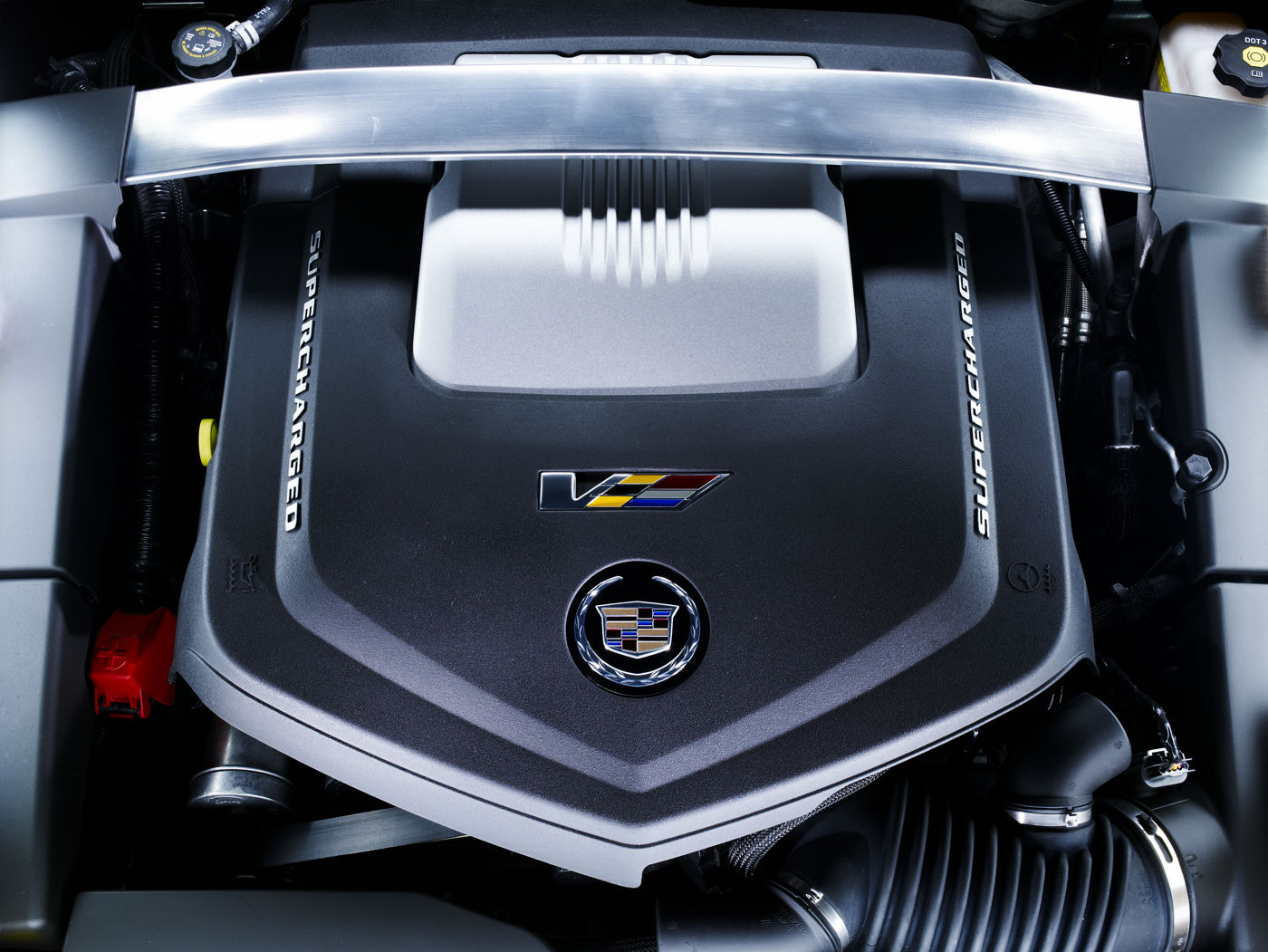 Engine cover of the supercharged 6.2-litre V-8 in a 2012 CTS-V, marked Supercharged with the V-Series badge