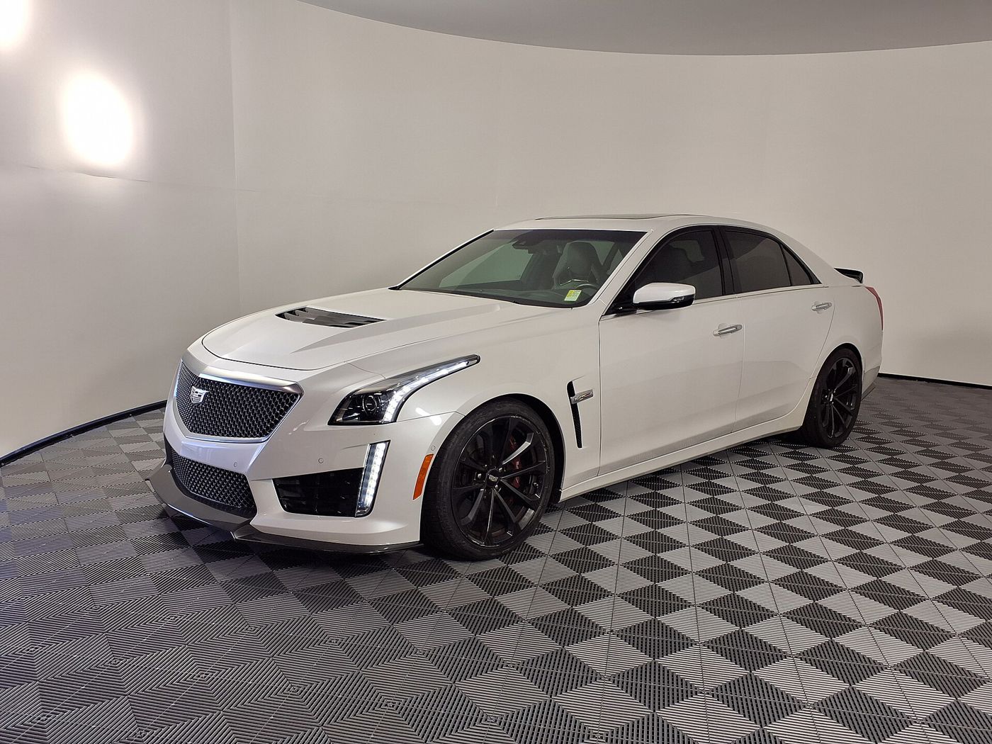 White 2019 Cadillac CTS-V sedan, front three-quarter, in a showroom