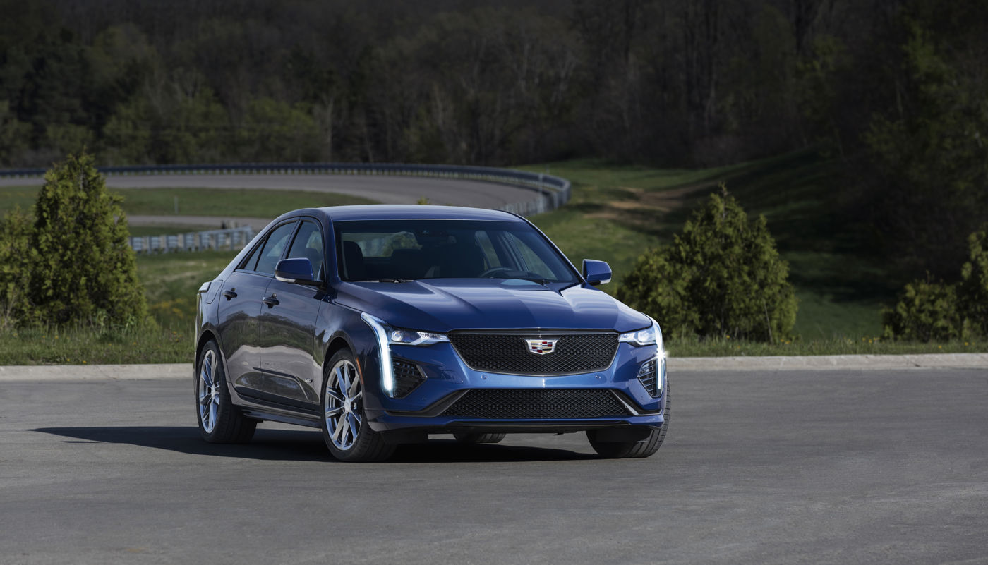 Blue 2020 Cadillac CT4-V sedan, front three-quarter, on a road course