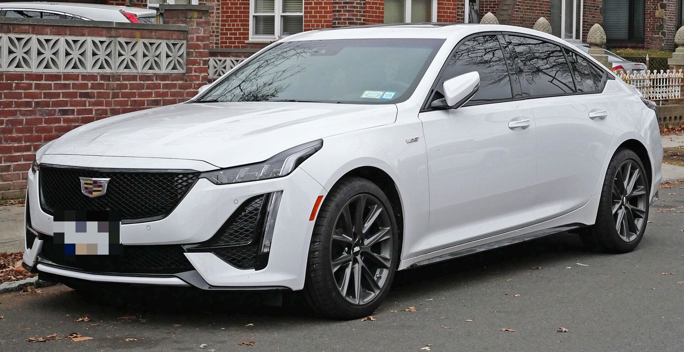 White 2024 Cadillac CT5-V sedan, front three-quarter, at a curb