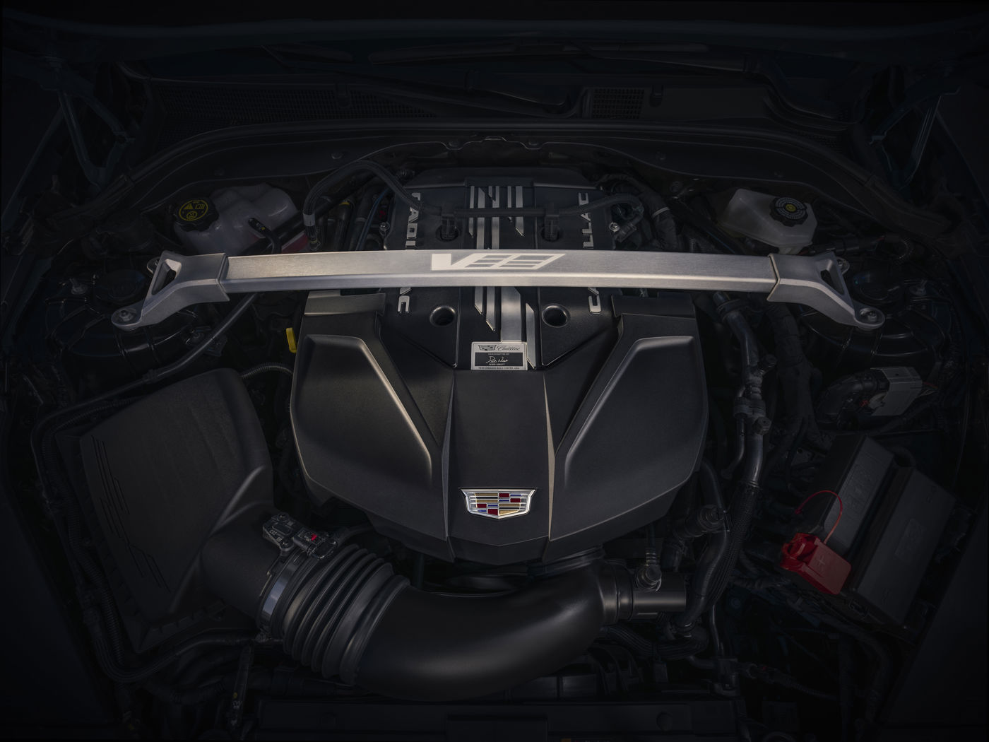 Engine bay of a 2026 CT5-V Blackwing with the supercharged V-8 cover under a strut brace
