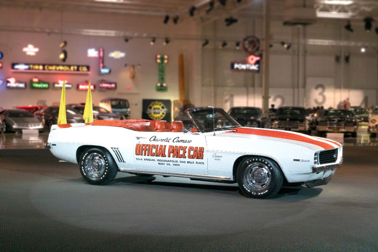 White 1969 Chevrolet Camaro SS convertible with Hugger Orange stripes, orange houndstooth interior, yellow flags and Official Pace Car door lettering for the 53rd Indianapolis 500, in the GM Heritage Center hall