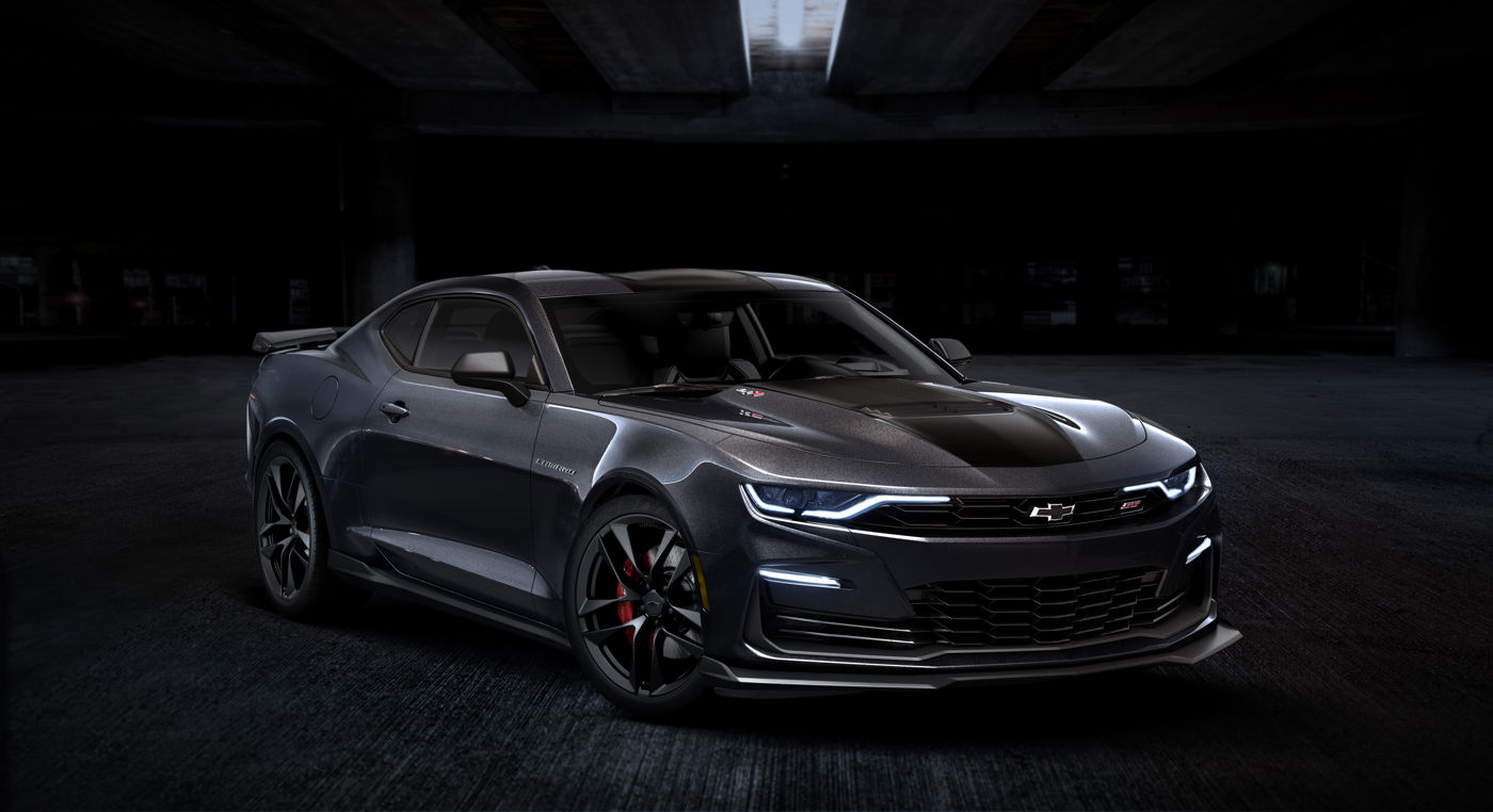 Dark gray 2024 Chevrolet Camaro SS Collector's Edition coupe in a dark studio, front three-quarter, with black hood stripe, SS grille badge, black wheels and red brake calipers