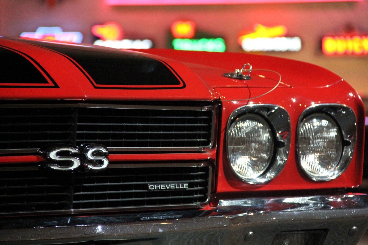 Close-up of the black-out grille of a red 1970 Chevrolet Chevelle SS, showing the SS grille badge, Chevelle script and dual headlamps