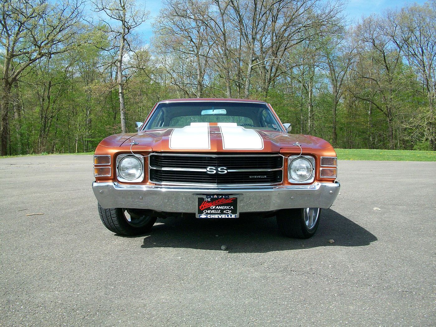 Head-on view of a copper 1971 Chevrolet Chevelle SS with white hood stripes, showing the SS grille badge, Chevelle grille script, single headlamps and split parking lamps