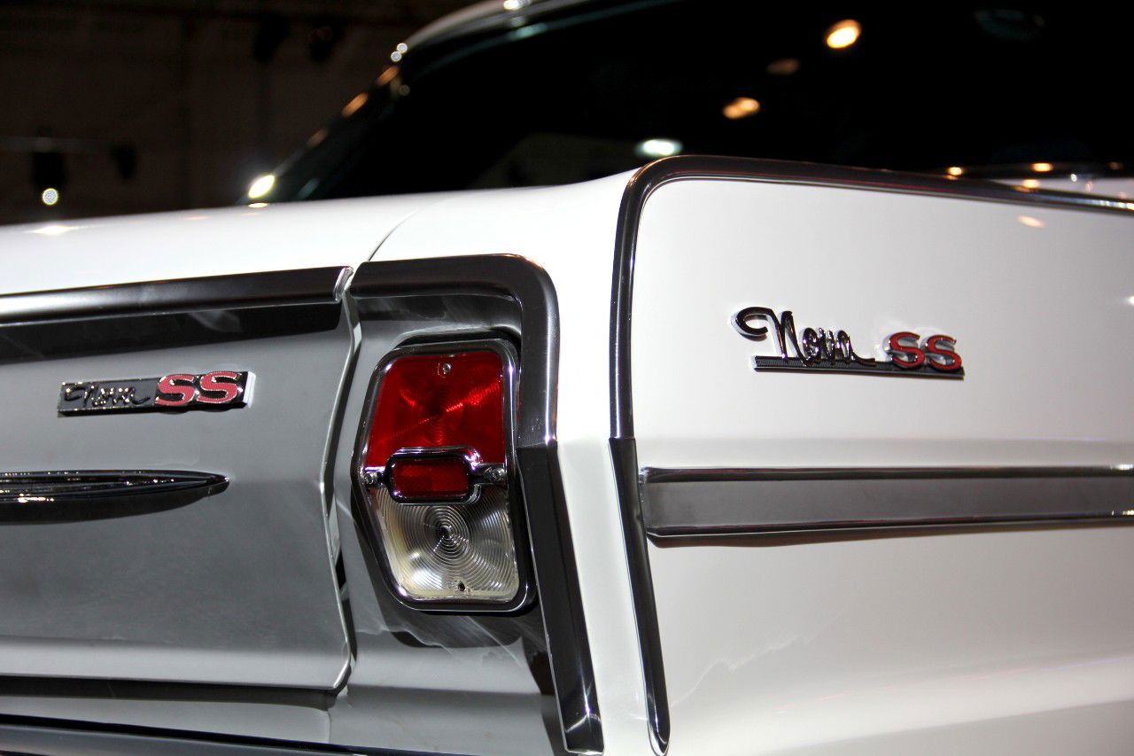 Close-up of the rear quarter of a white 1963 Chevy II Nova SS, showing the Nova SS script, the SS emblem on the trim panel and the round taillamp