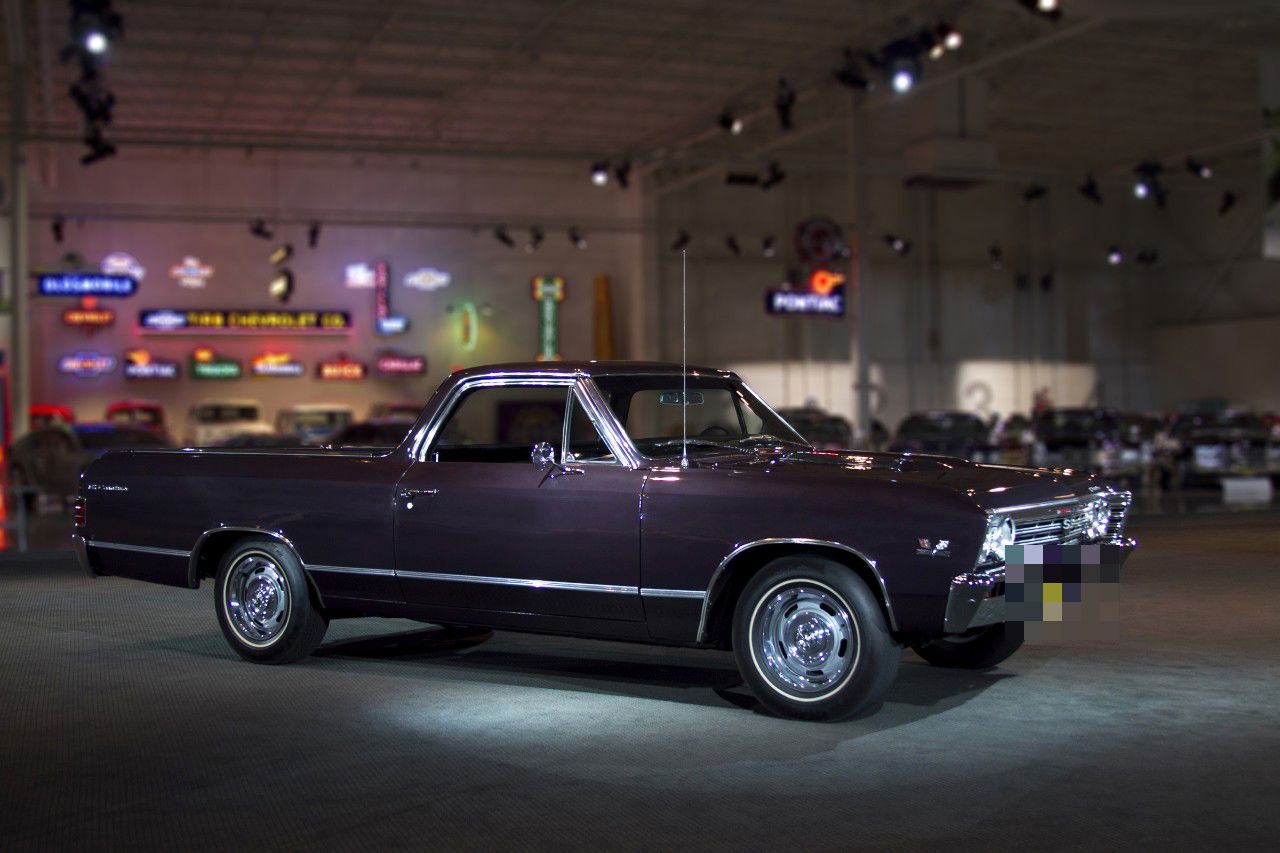 Dark maroon 1967 Chevrolet El Camino SS 396 pickup in the GM Heritage Center hall, side and front three-quarter view, with SS grille badge, 396 fender emblem and Rally wheels