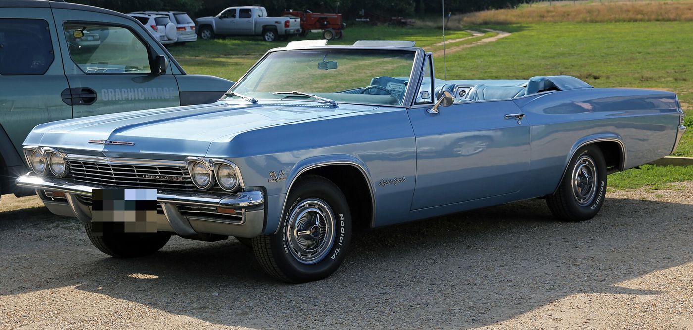 Light blue 1965 Chevrolet Impala SS convertible with the top down, front three-quarter, showing the Impala SS grille badge and Super Sport script on the front fender