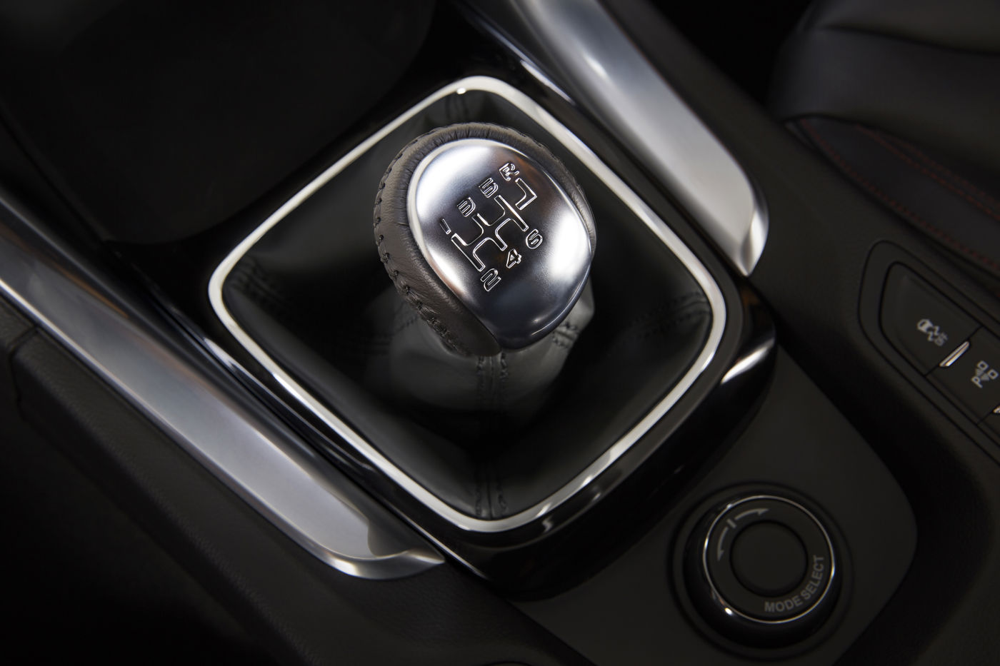 Close-up of the six-speed manual gear lever and its shift pattern in the center console of a 2015 Chevrolet SS