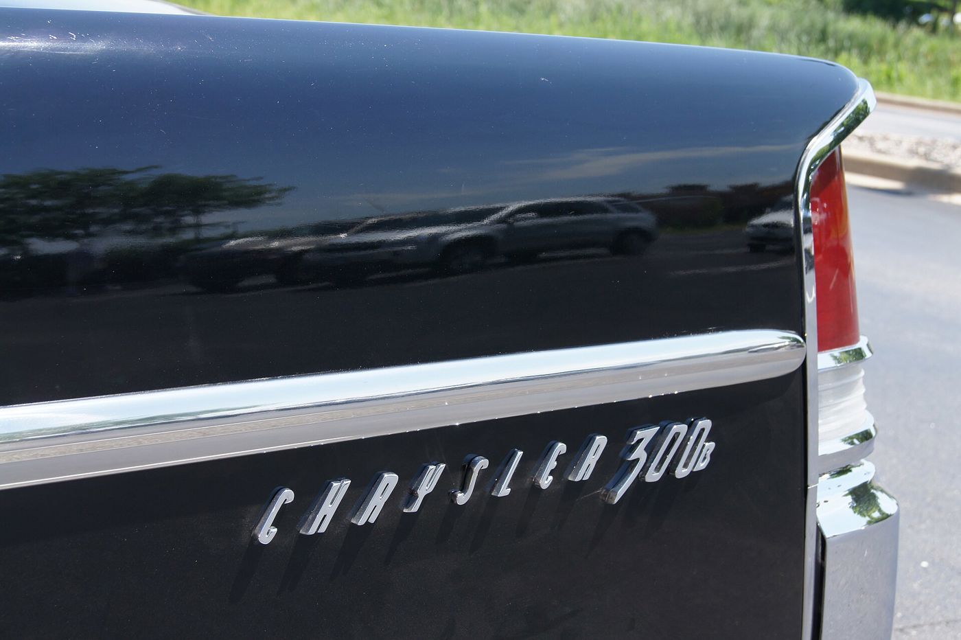 Chrome Chrysler 300B script on a black rear fender beside the tall tail fin
