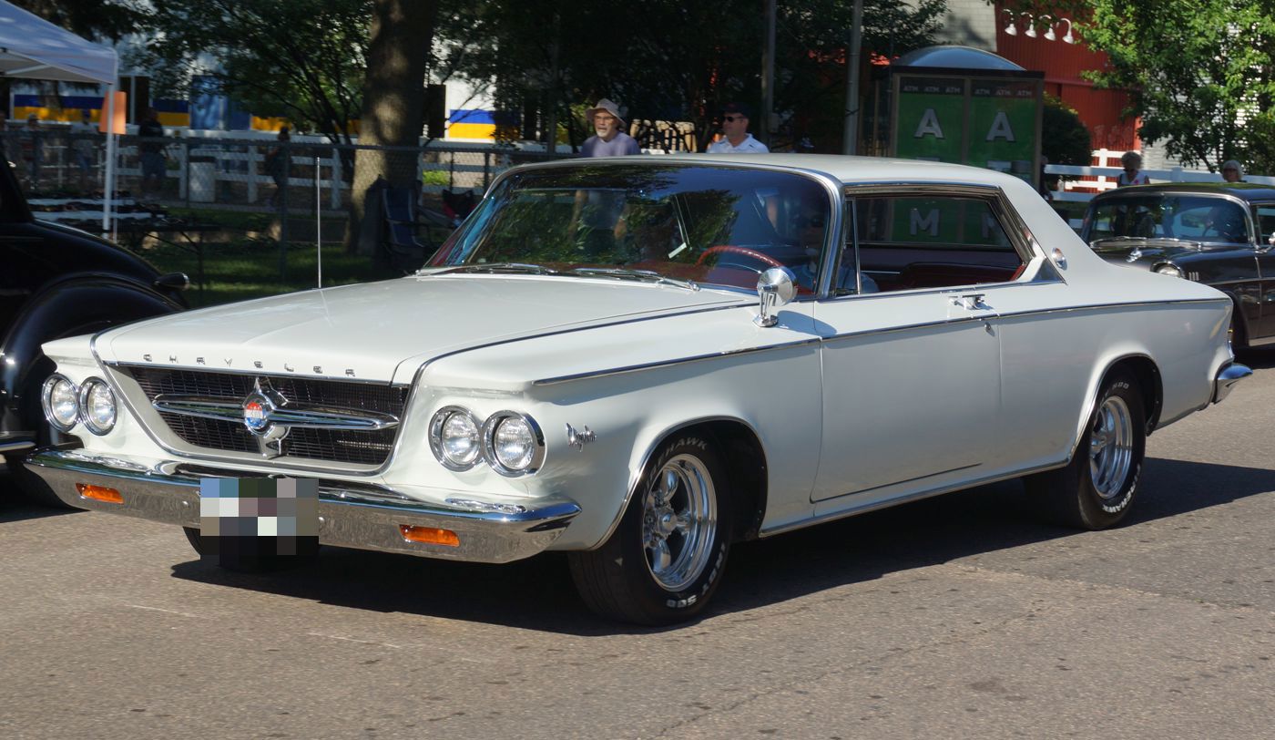 White 1963 Chrysler 300 two-door hardtop with its squared-off body and quad headlamps, front three-quarter