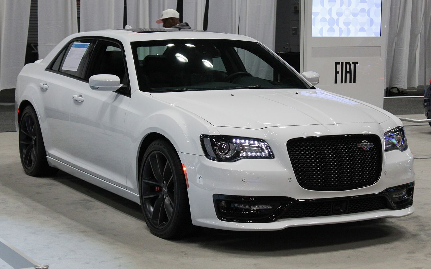 White 2023 Chrysler 300C with black mesh grille and dark wheels at the 2023 New York auto show