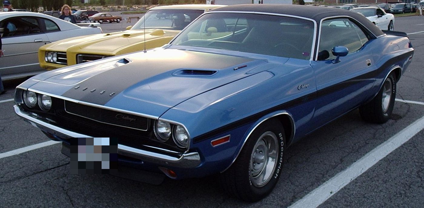Blue 1970 Dodge Challenger with black roof, quad headlamps in the recessed grille, and power-bulge hood