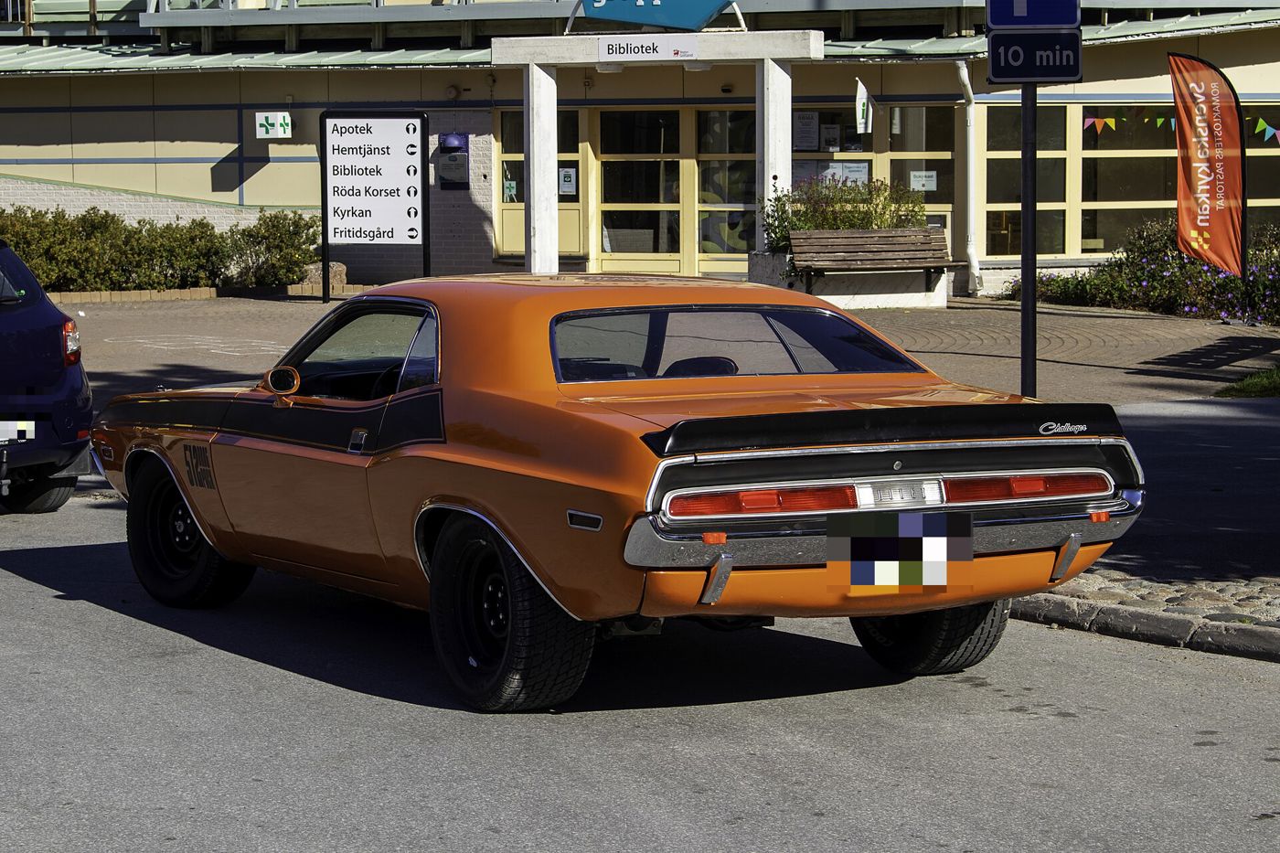Bronze 1970 Dodge Challenger from the rear three-quarter with its full-width taillamps and black tail panel stripe
