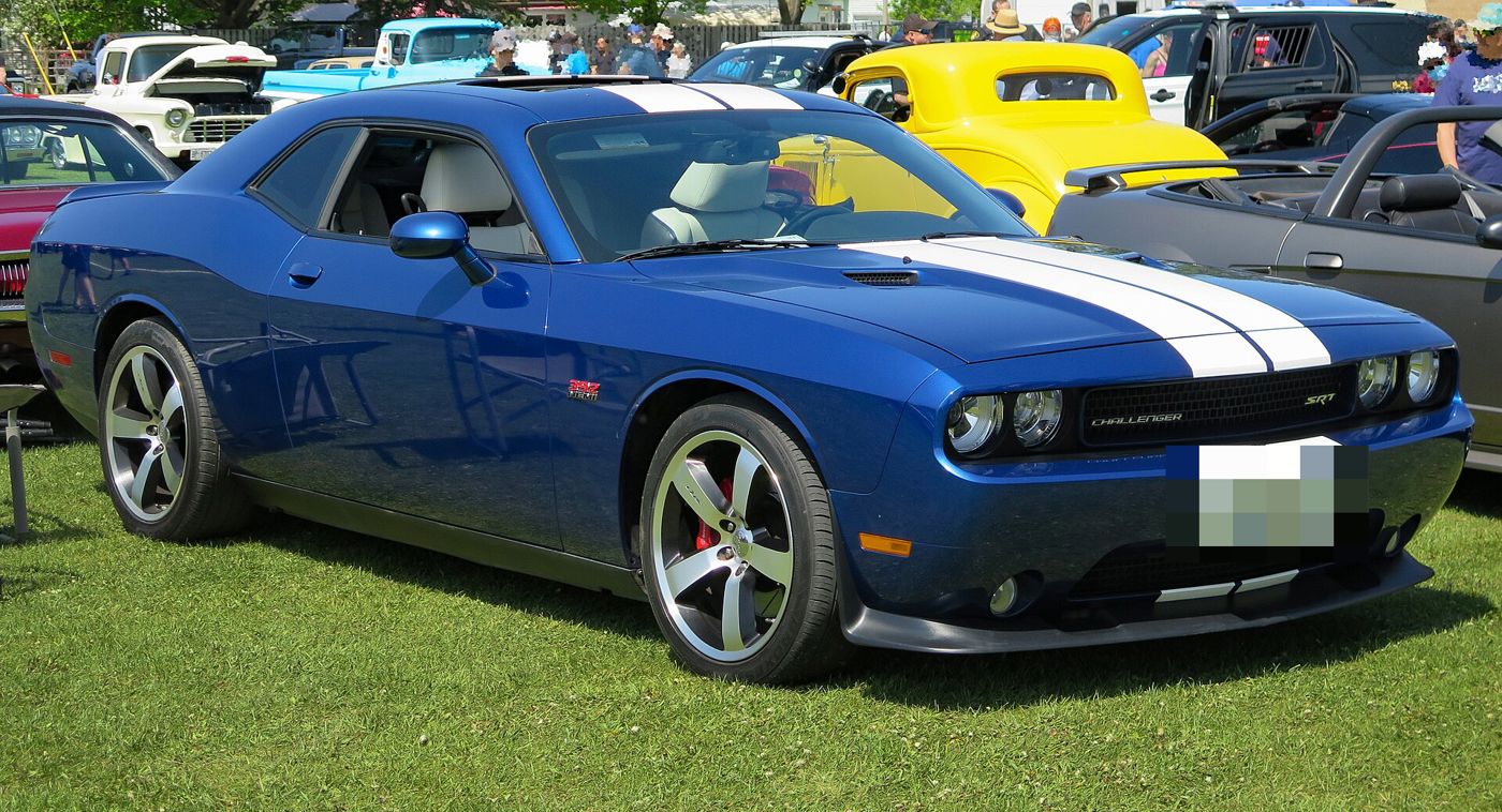 Blue 2011 Dodge Challenger SRT8 392 Inaugural Edition with white racing stripes, front three-quarter on grass