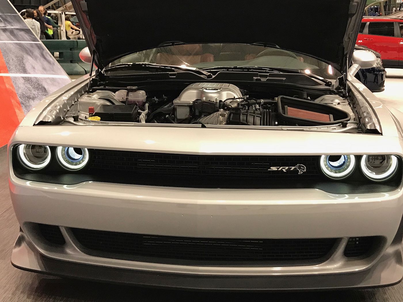 Silver 2019 Dodge Challenger SRT Hellcat Redeye seen head-on at an auto show with the hood raised