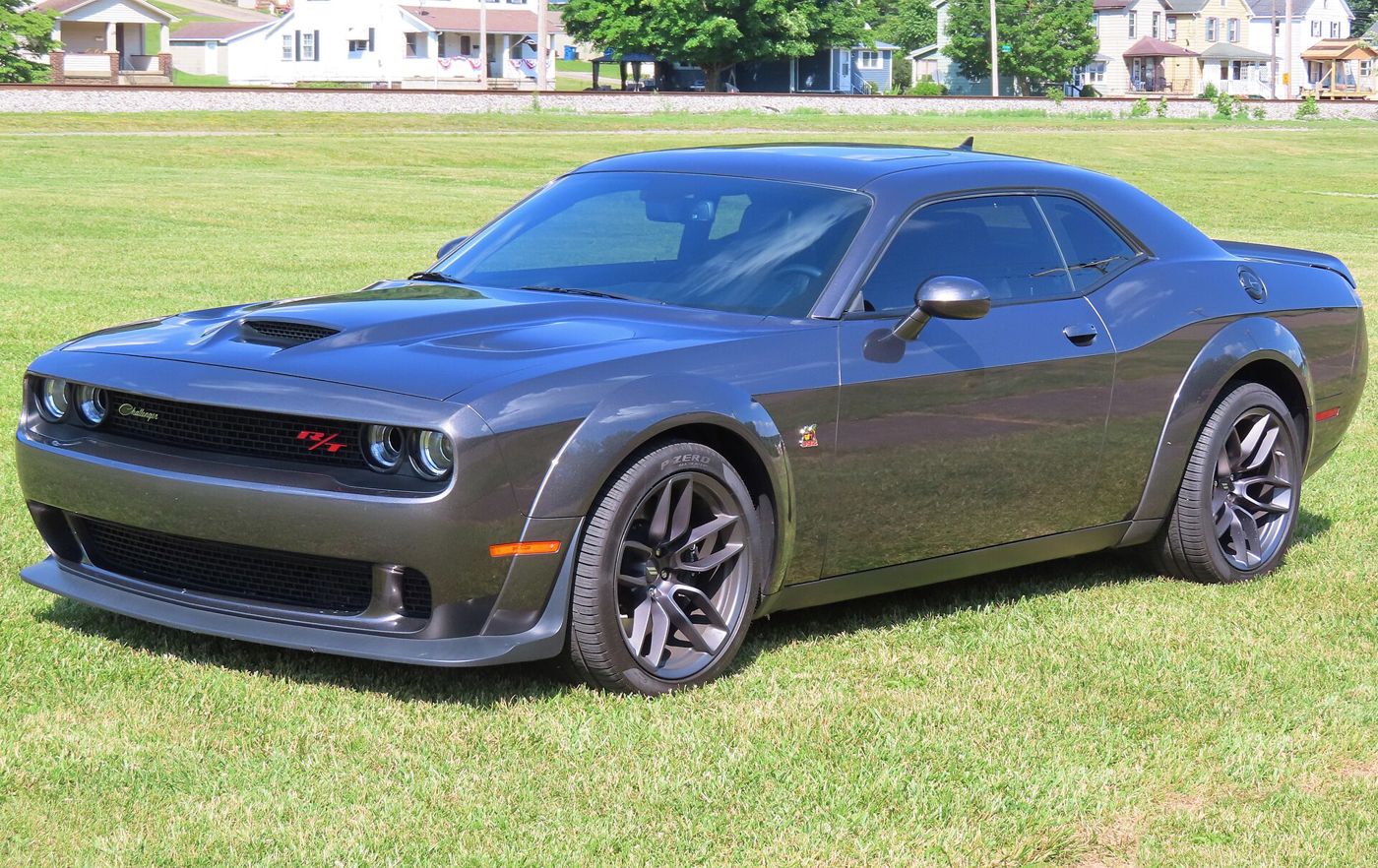 Grey 2020 Dodge Challenger R/T Scat Pack Widebody with flared fenders, front three-quarter on grass