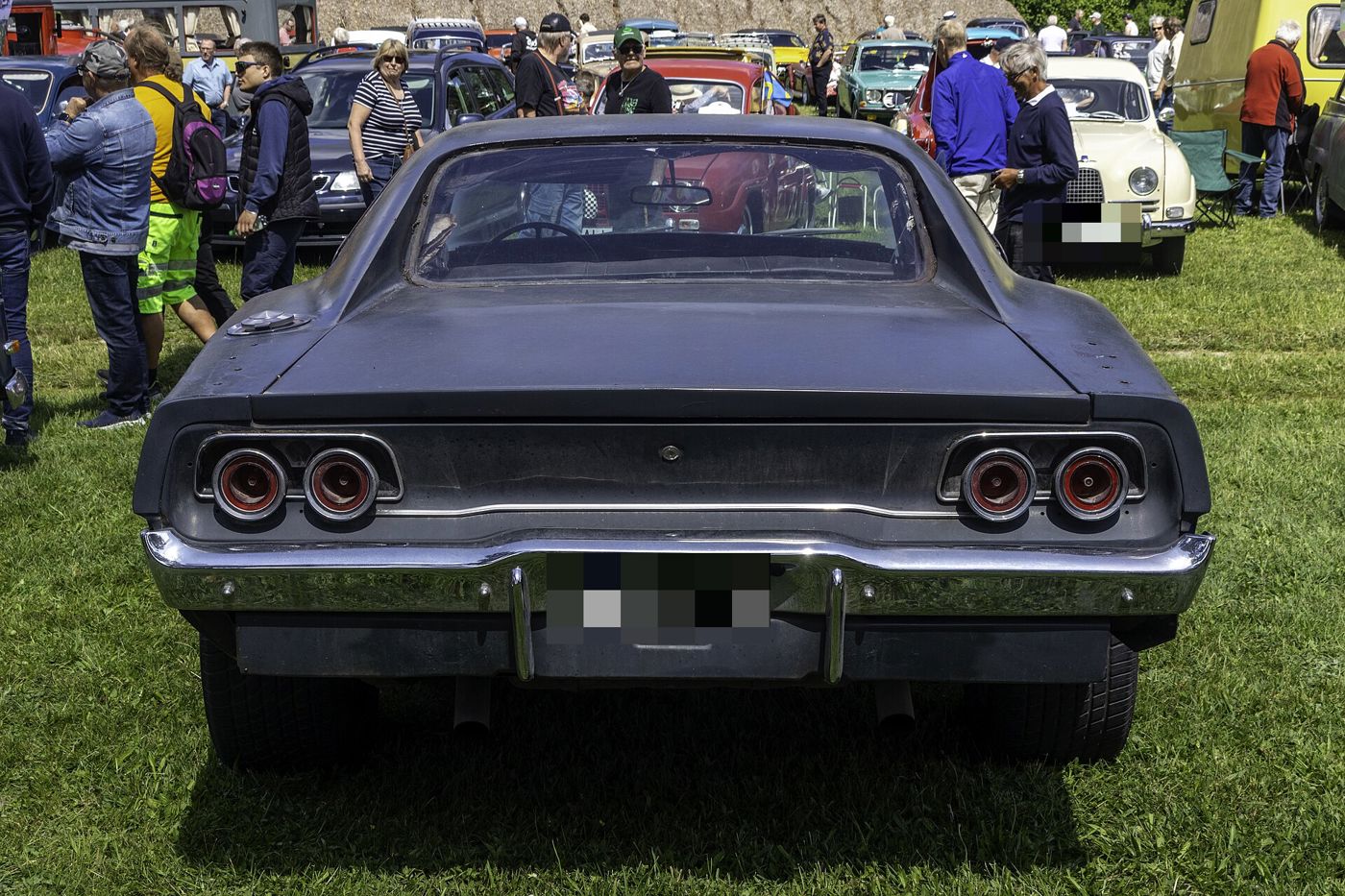 Rear of a dark 1968 Dodge Charger with its four round taillamps and flying-buttress roof