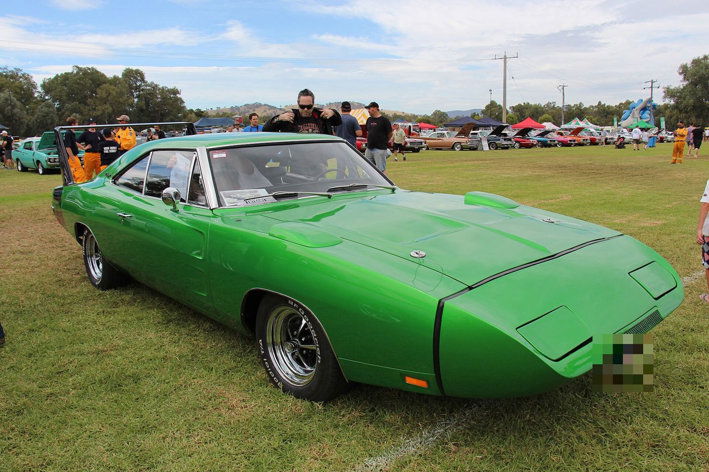 Green 1969 Dodge Charger Daytona from the front three-quarter with its long pointed nose cone and flush rear window