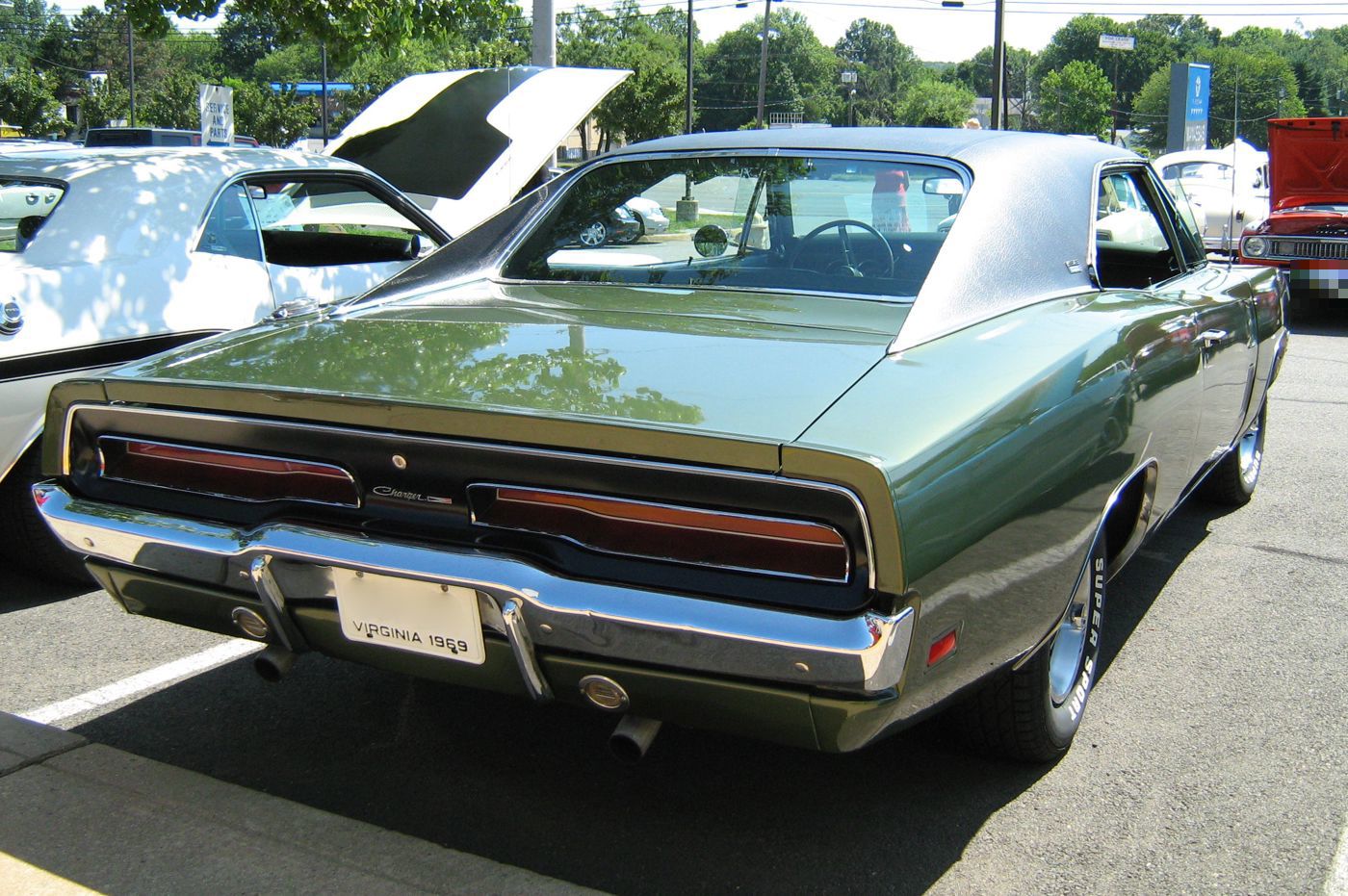 Green 1969 Dodge Charger from the rear three-quarter with its full-width horizontal taillamps and flying-buttress roof