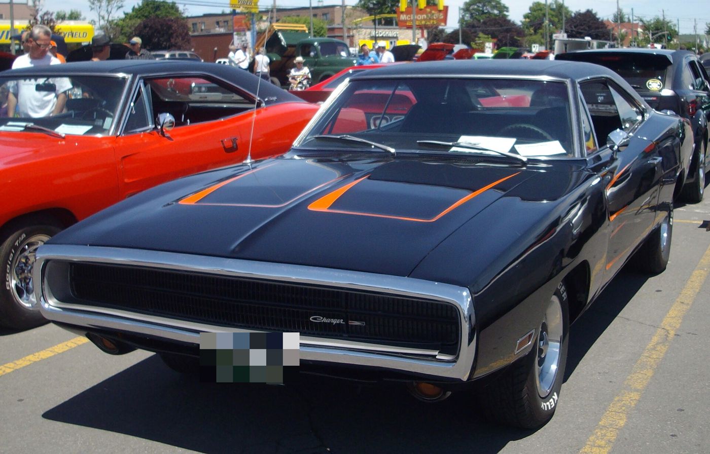 Black 1970 Dodge Charger with orange hood stripes and the chrome loop front bumper