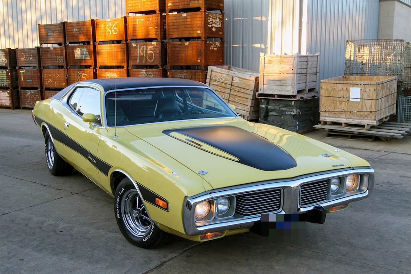 Yellow 1974 Dodge Charger Rallye with black hood and side stripes, front three-quarter view