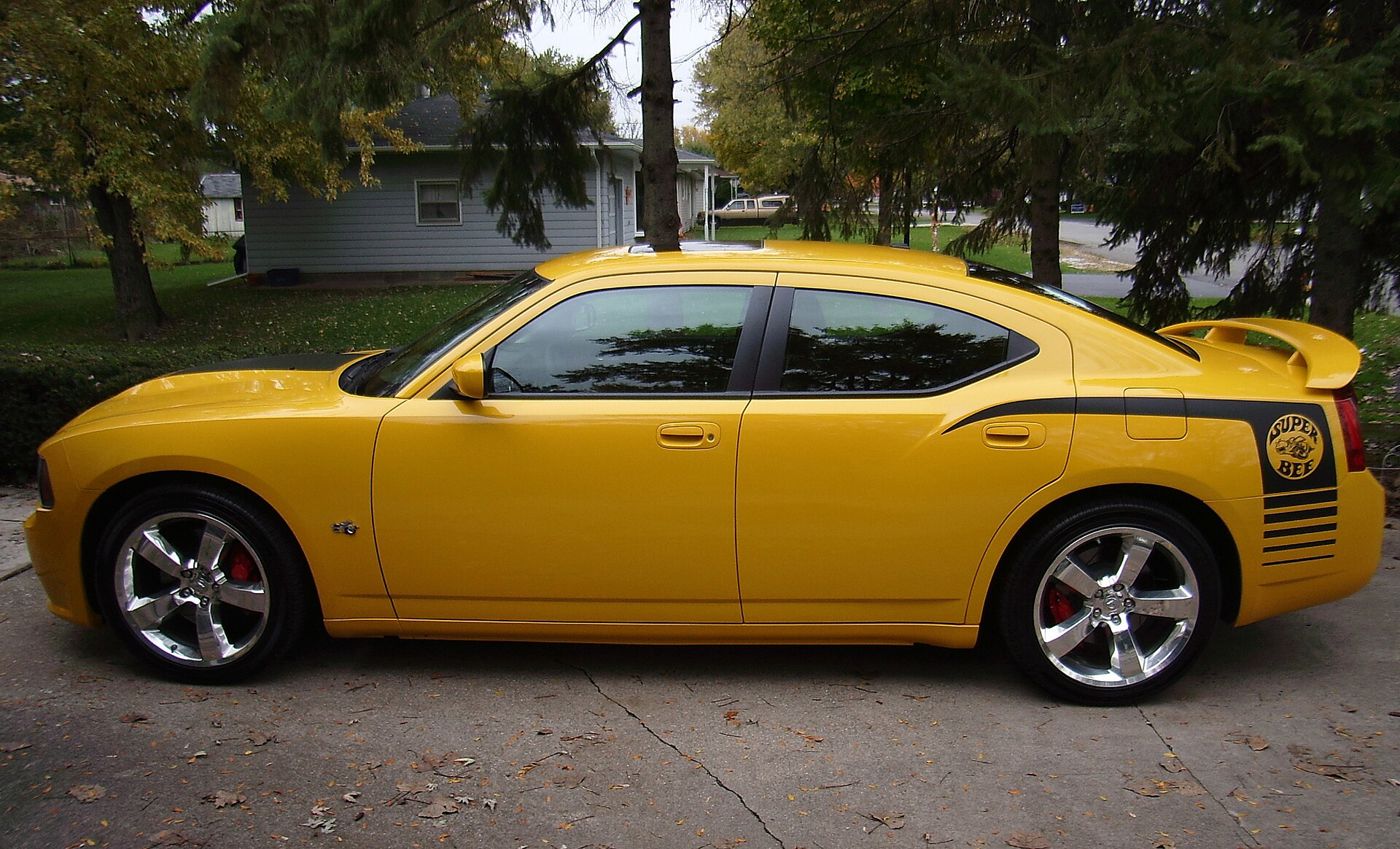 Yellow 2007 Dodge Charger SRT8 Super Bee in profile, with the black Super Bee emblem and stripes on the rear quarter