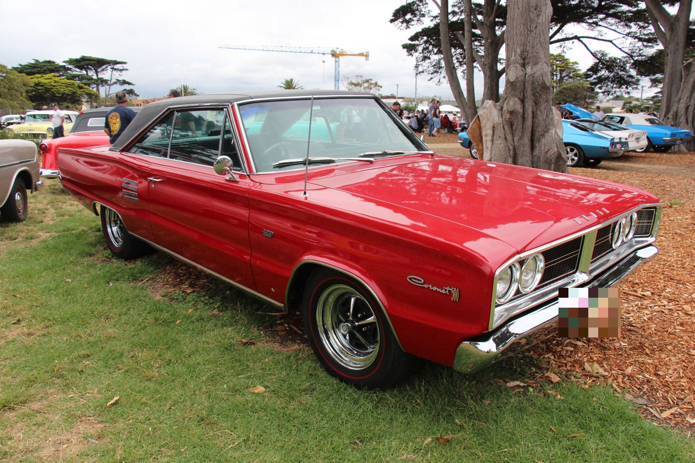 Red 1966 Dodge Coronet 500 hardtop with black vinyl roof and Coronet script on the front fender