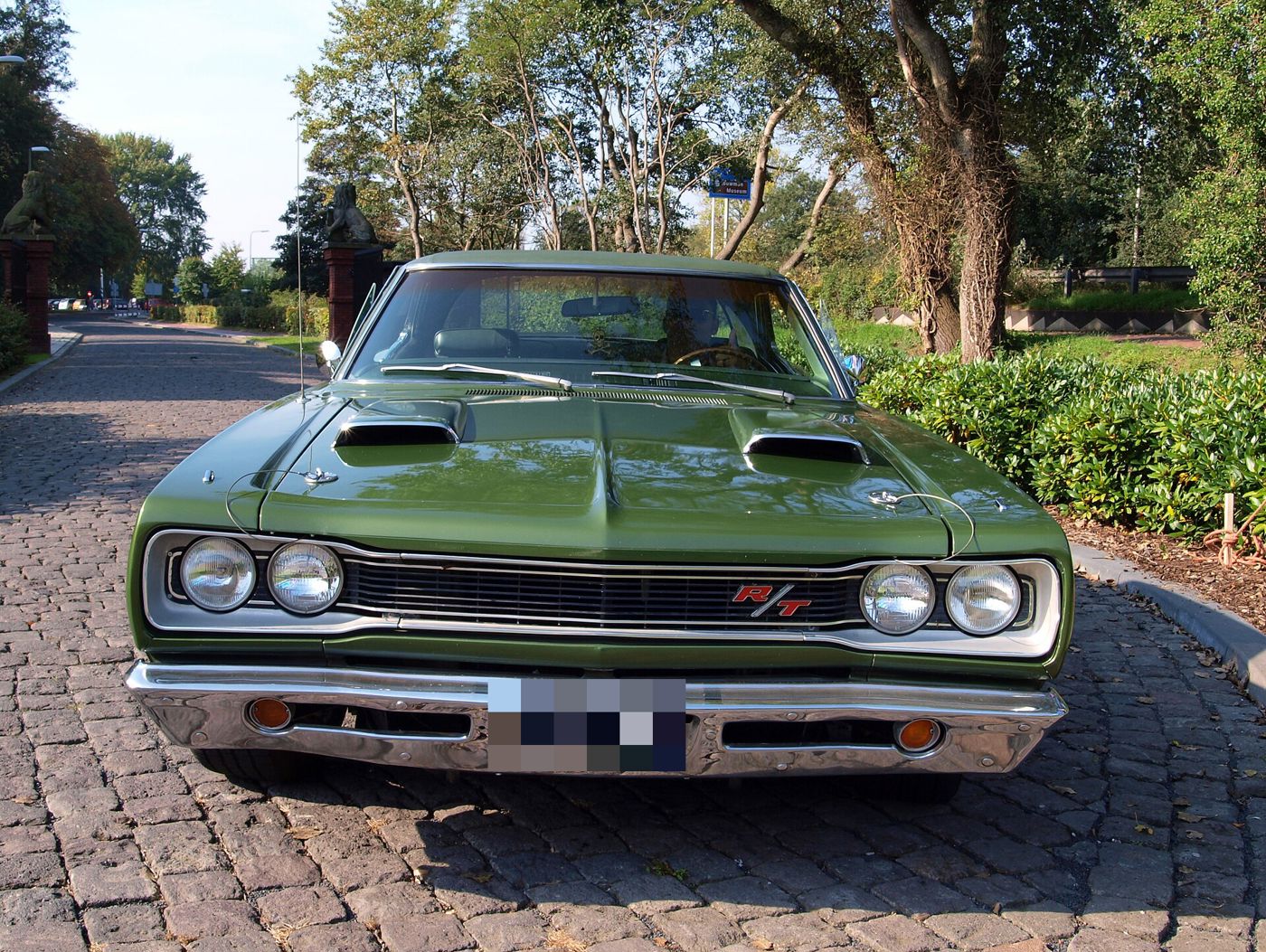 Green 1969 Dodge Coronet R/T seen from the front, showing the R/T grille badge and twin hood scoops