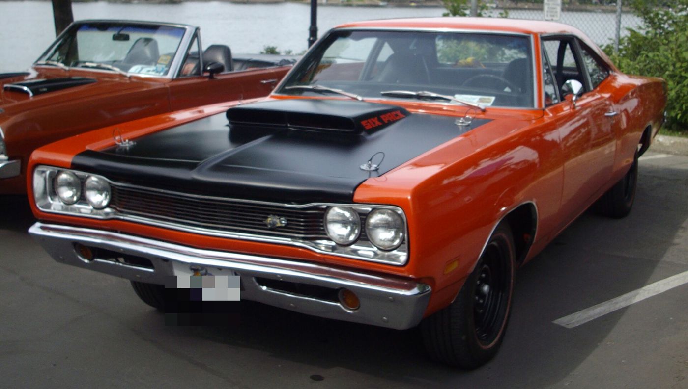 Orange 1969 Dodge Super Bee Six Pack with a matte-black hood and large scoop, front three-quarter