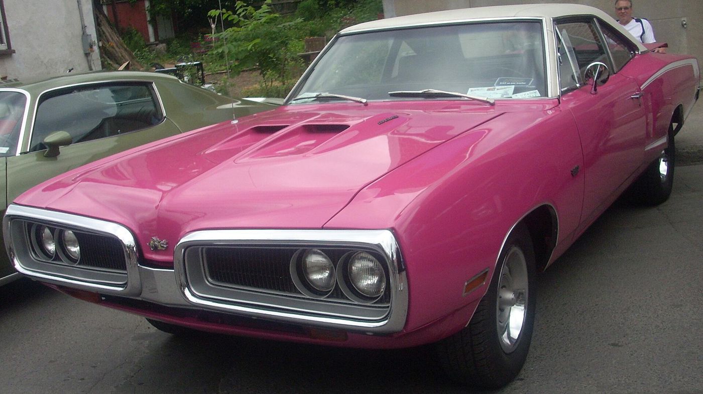 Magenta 1970 Dodge Super Bee with white vinyl roof and twin-loop grille, front three-quarter