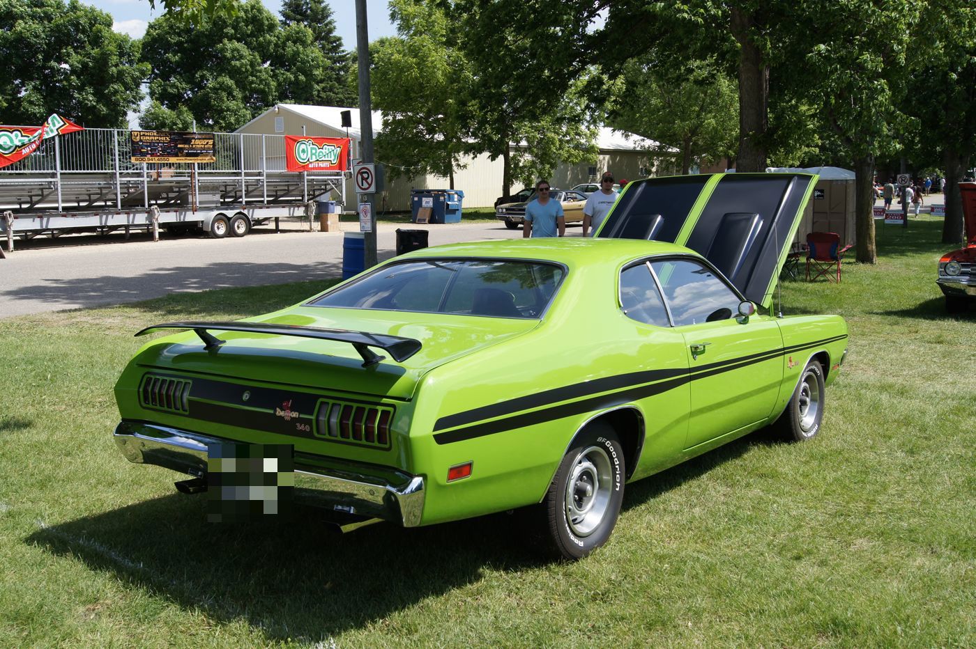 Green 1971 Dodge Demon 340 from the rear three-quarter, with black side stripes, rear wing and the Demon tail emblem