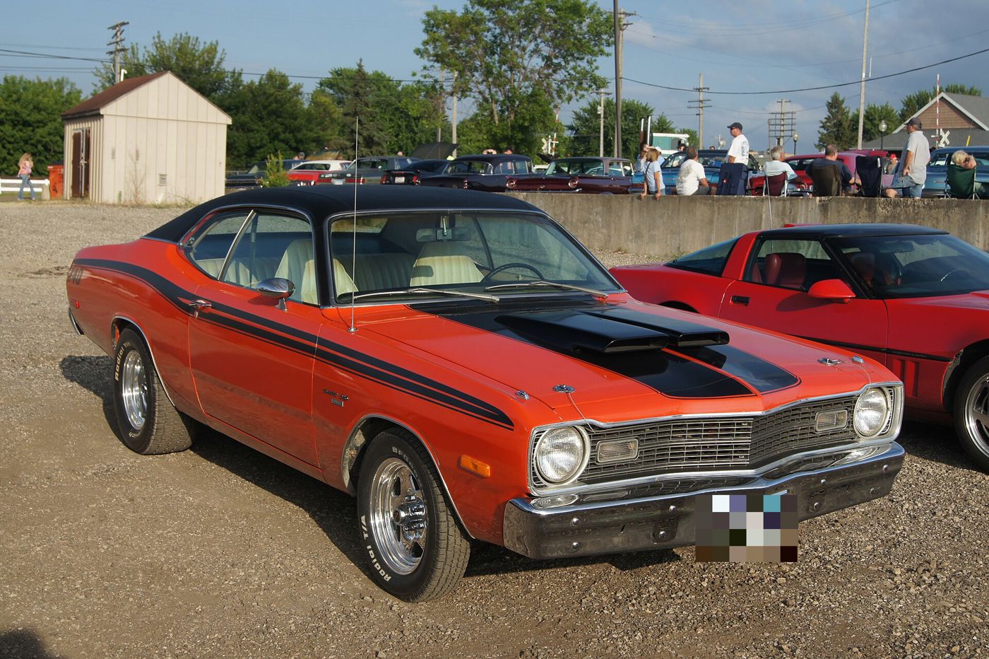 Orange 1973 Dodge Dart Sport with black vinyl roof, black hood treatment and side stripes, front three-quarter