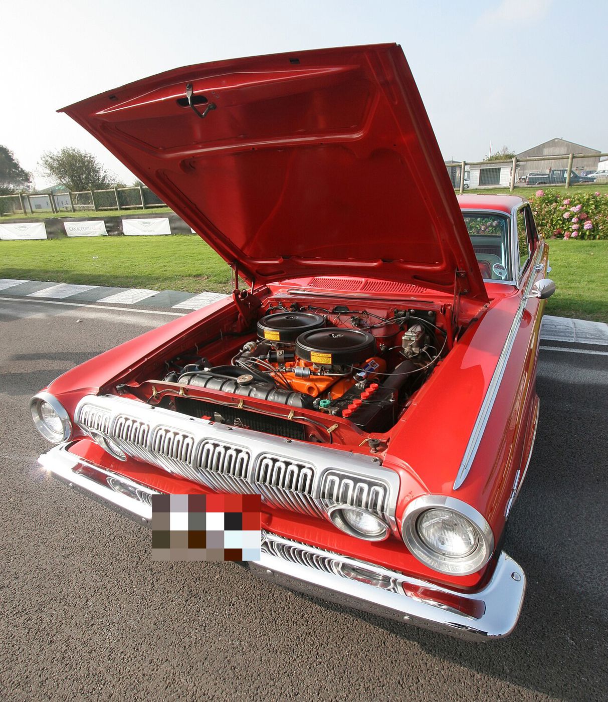 Red 1963 Dodge Polara with the hood raised, showing an orange Max Wedge V8 with twin air cleaners behind the 1963 grille