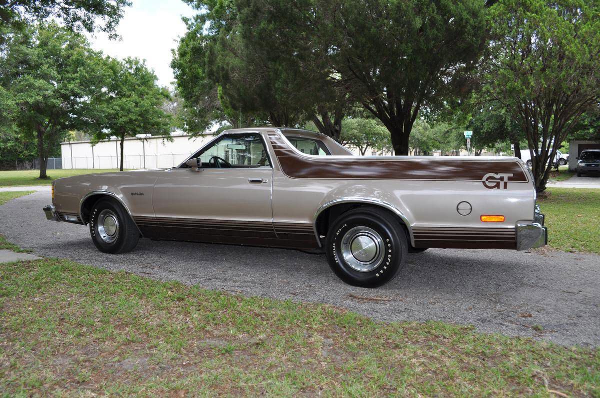 Tan 1977 Ford Ranchero GT in side view on a gravel drive, with brown body-side graphics ending in large GT lettering on the bed side