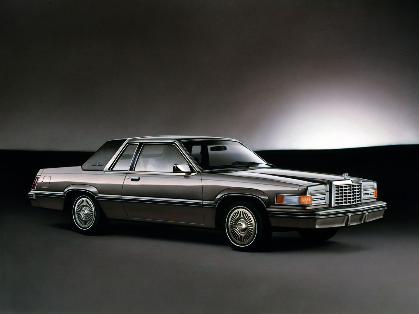 Grey 1982 Ford Thunderbird coupe with wire wheel covers, front three-quarter studio view